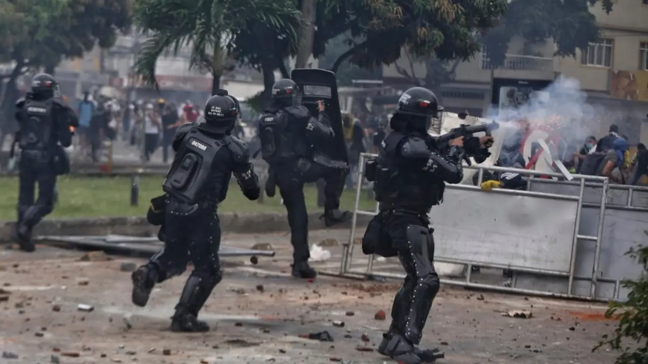 Police fire tear gas at protesters during a national strike against tax reform in Cali, Colombia, Monday, May 3, 2021. Colombia's President Ivan Duque withdrew the government-proposed tax reform on Sunday. (AP Photo/Andres Gonzalez)